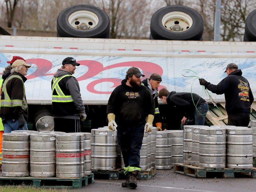 Driver charged after load of beer kegs tumbles off truck in Brockville crash